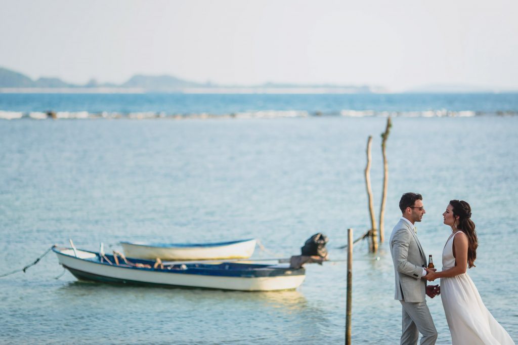 bride and groom hold hands on the beach at villa ban laem sor koh samui thailand