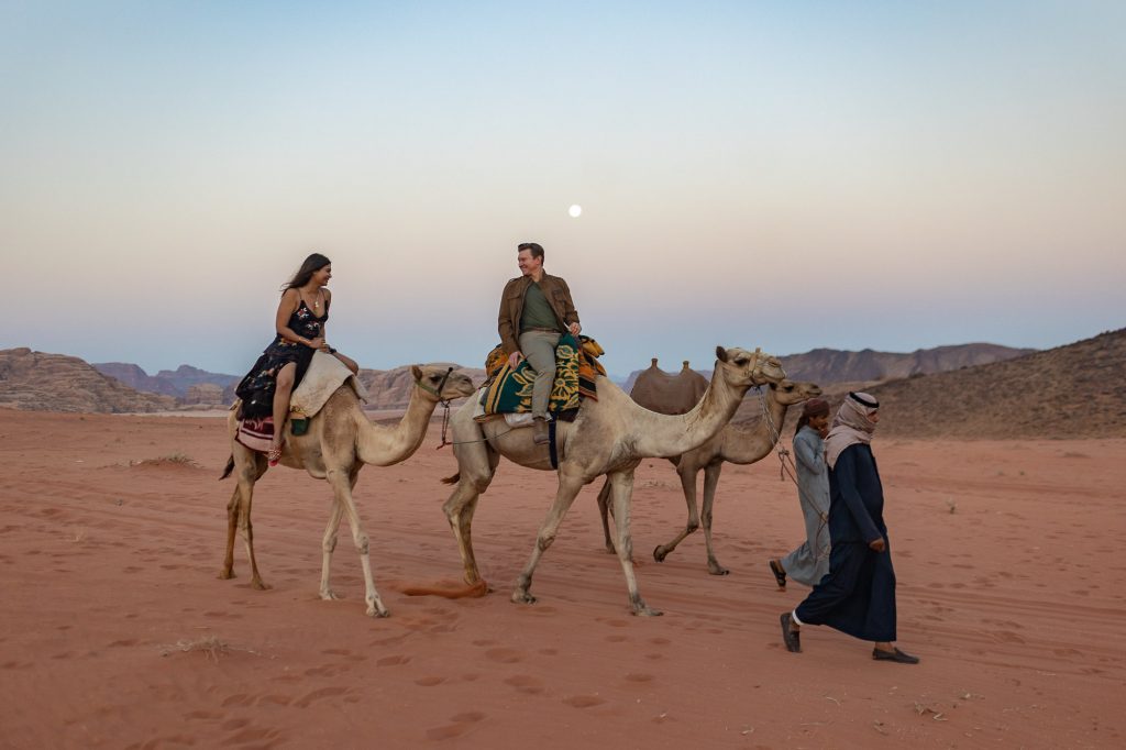 couple on a camel ride in wadi rum in jordan
