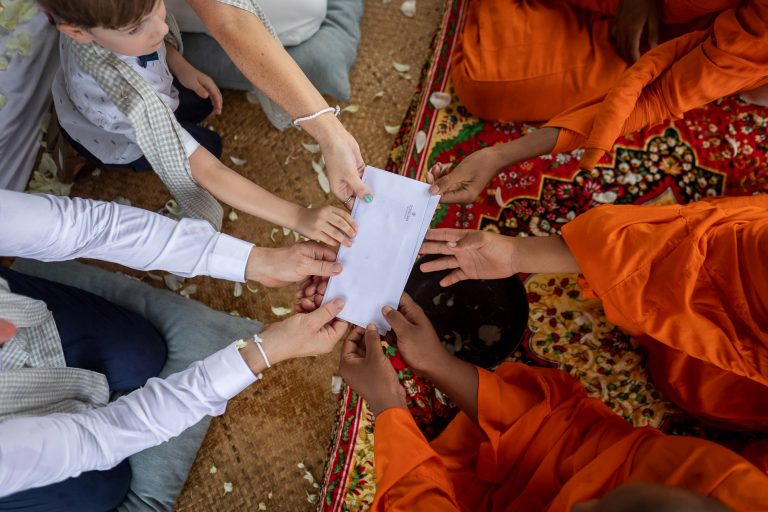 bride and groom and monks hold their wedding certificate at their destination wedding at Song Saa Private Island in Cambodia