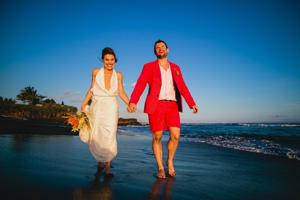 bride and groom laugh on beach at Mahatma House Canggu Bali wedding