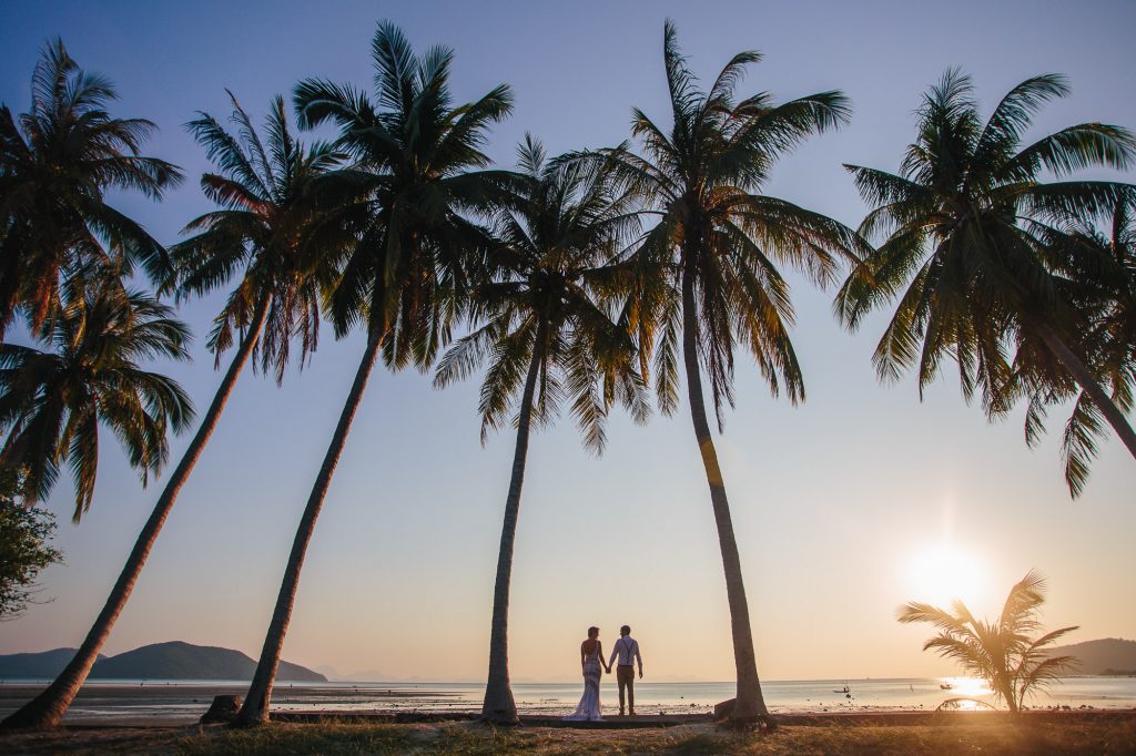 bride and groom under palm trees at Ban Sairee Koh Samui Thailand