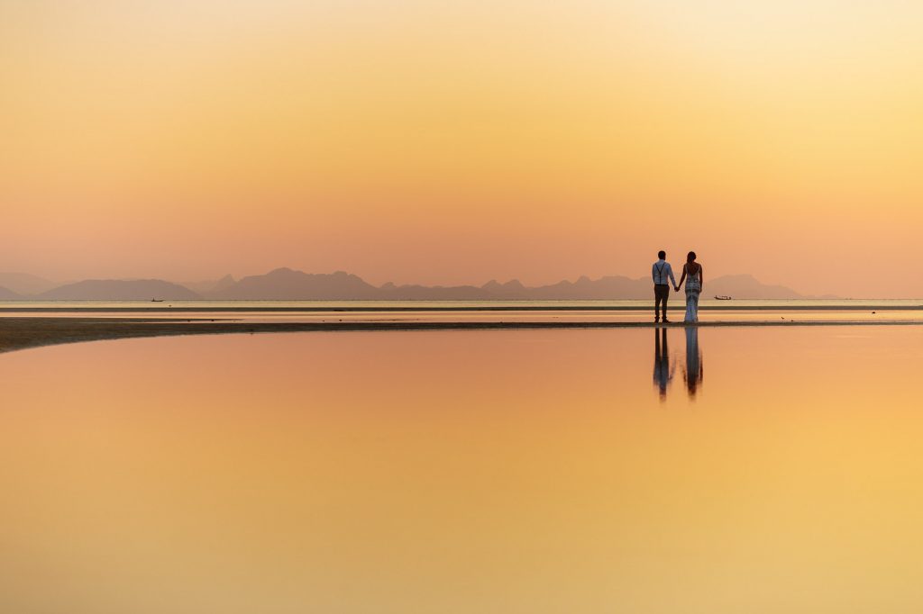 bride and groom walk at sunset at Ban Sairee Koh Samui Thailand