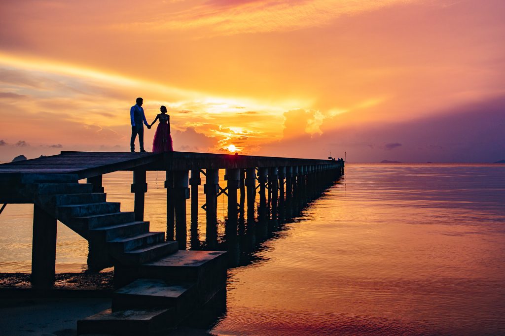 bride and groom watch the sunet at their indian wedding koh samui at intercontinental taling ngam bay