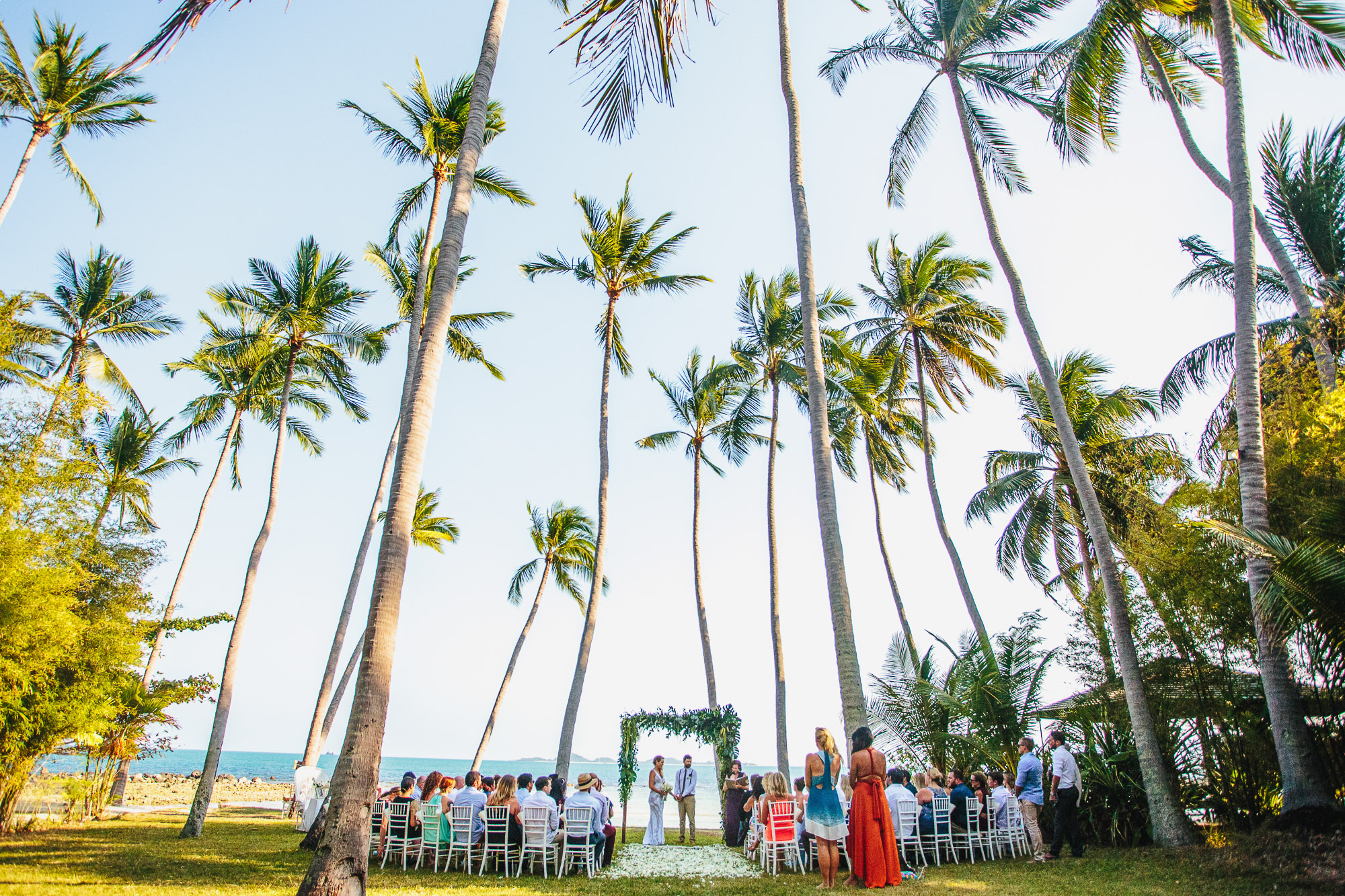 bride and grooms destination wedding ceremony under coconut tress at Ban Sairee Koh Samui Thailand