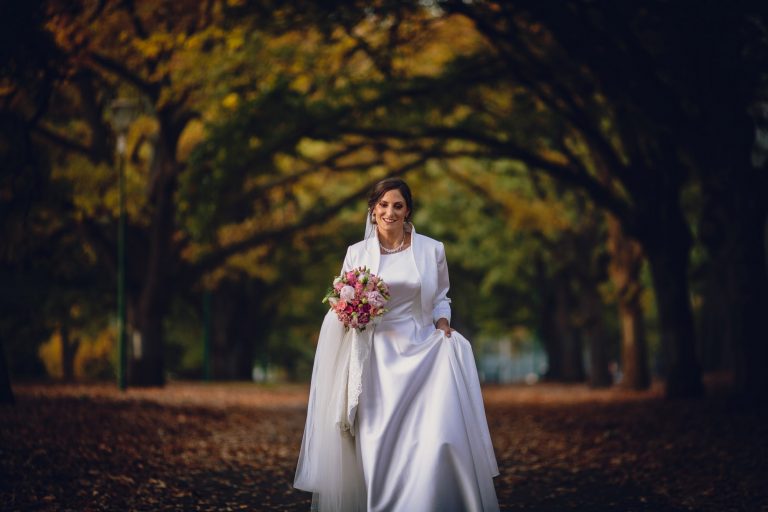 bride walking in carlton gardens before their melbourne wedding australia
