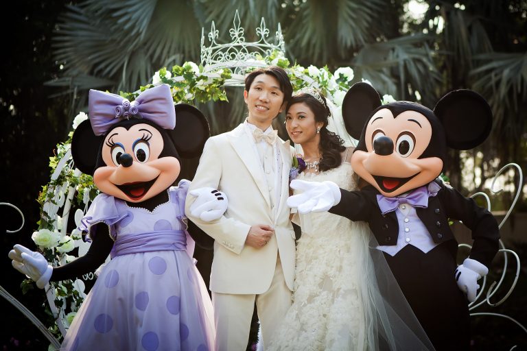 bride and groom with minnie and mickey mouse at disneyland hong kong