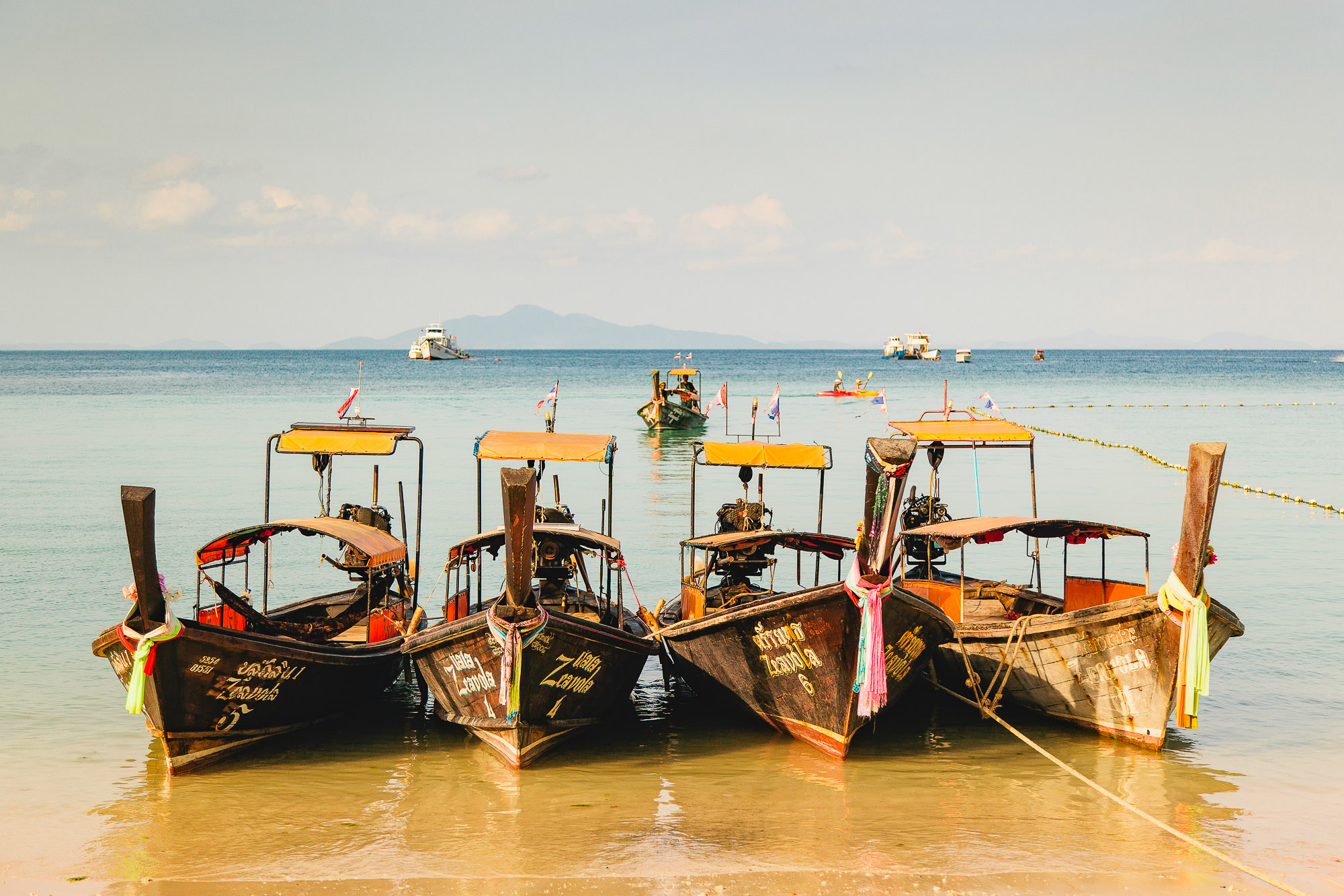 longtail boats near Zeavola resort and spa wedding venue in koh phi phi krabi province thailand