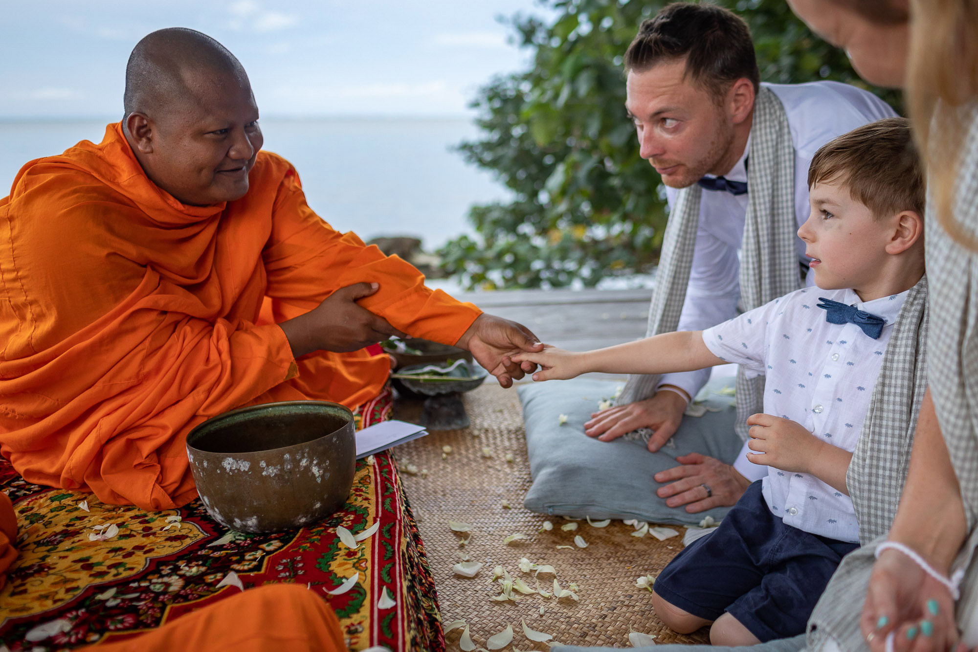 monk and bride and grooms son at a wedding in Song Saa Private Island in Cambodia