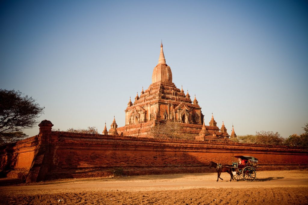 horse and cart go past a temple in Bagan by Myanmar photographer