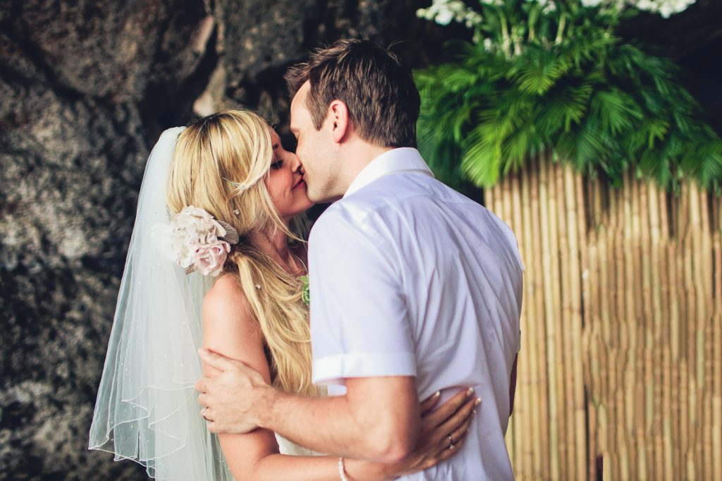 bride and groom kiss in the grotto at Phranang beach krabi thailand