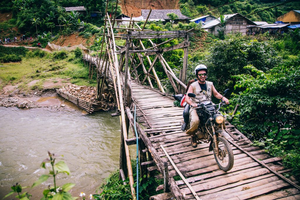 wedding guest on motorbike crosses a bridge after the vietnam wedding