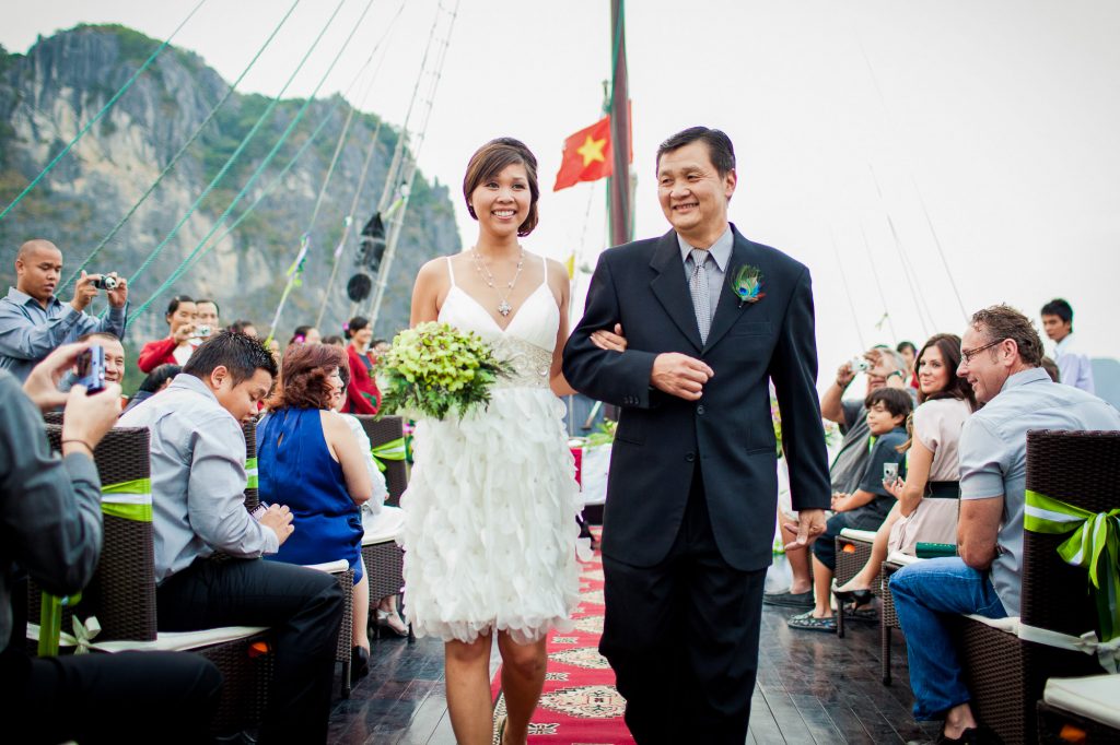 bride and father walking down the aisle on the Bhaya cruise boat at the Halong Bay Vietnam wedding